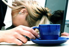 exhausted-woman with head down at desk