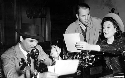 Rosalind Russell doesn't have time to take off her hat when she's typing her notes in "The Front Page."